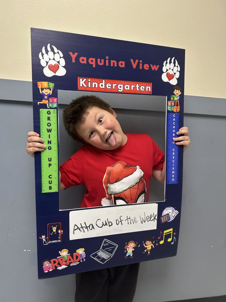 Smiling boy holding Atta Cub Kid of the week frame.