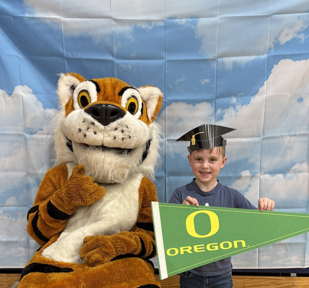 Oceanlake Family Literacy Night Attendee with Tiger Mascot