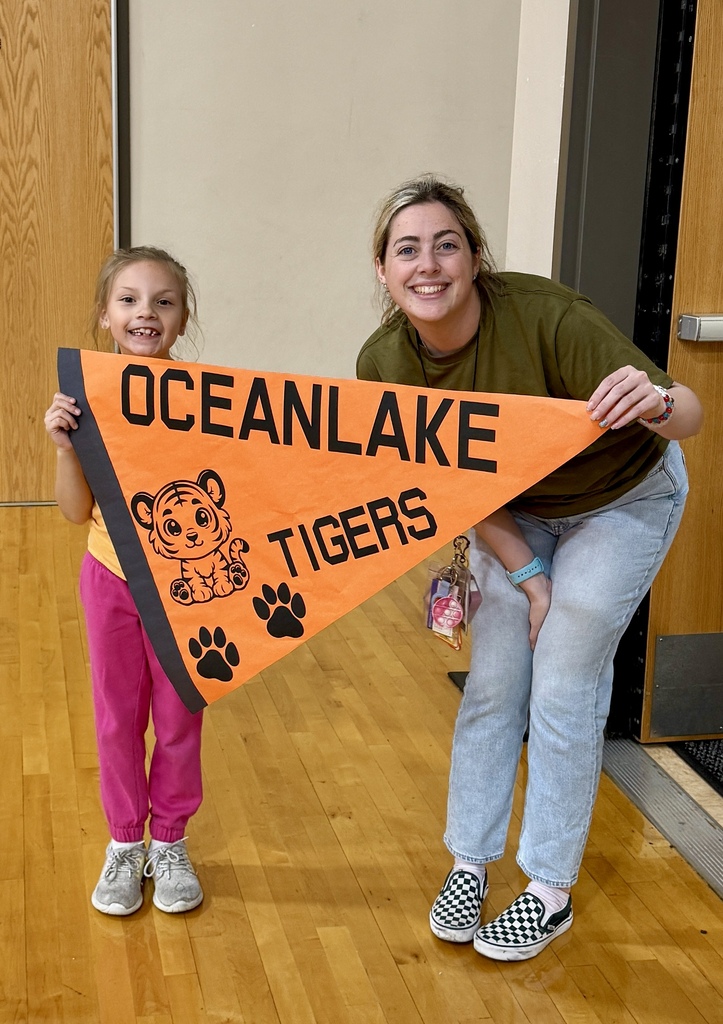 Family Night Attendees posing with an Oceanlake pennant