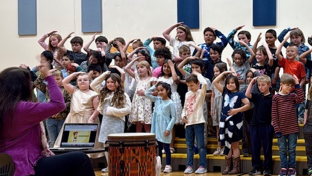 Photo of students performing in the gymnasium during OLES concert