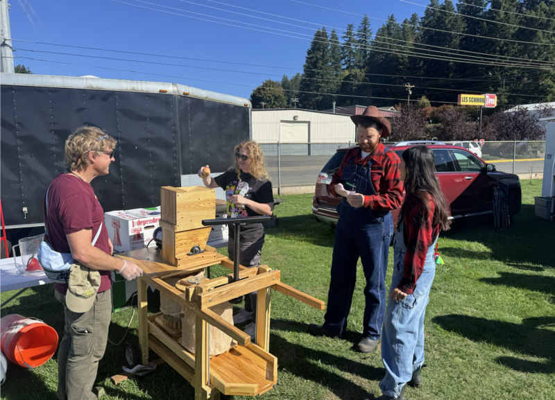 two men and two women preparing to press apples