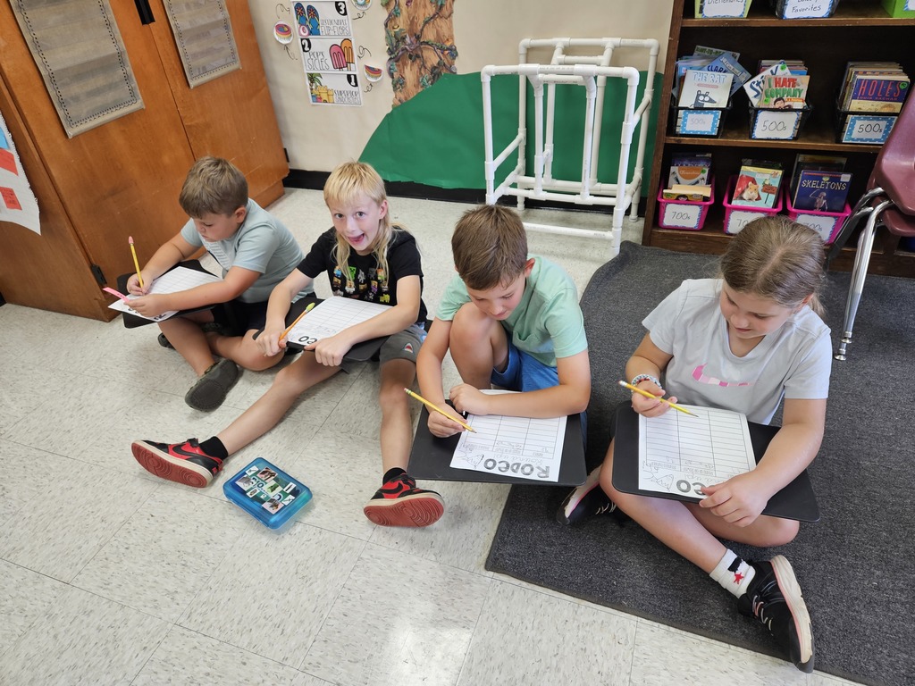 Students work in groups to practice rounding numbers. 