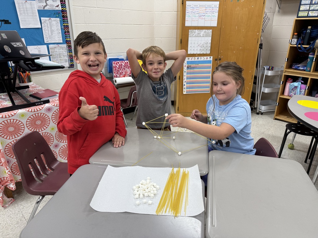 Students work on building structures with marshmallows and spaghetti.