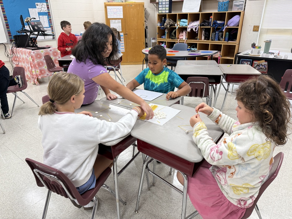 Students work on building structures with marshmallows and spaghetti.