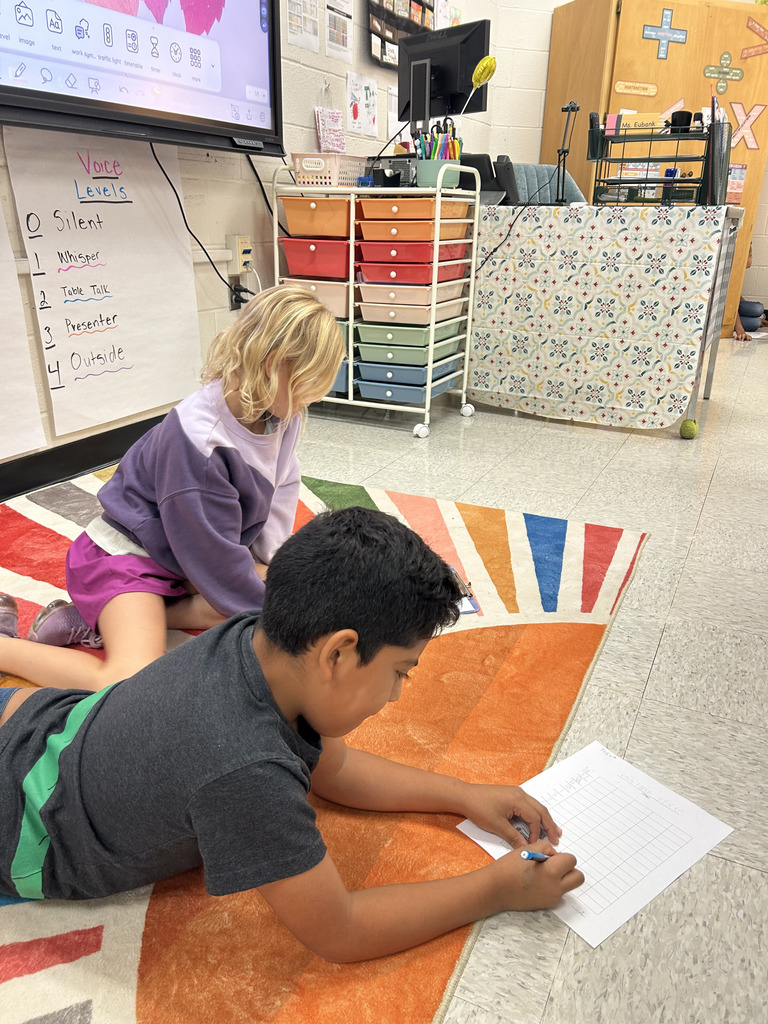 Students play rock, paper, scissors to make bar graphs.