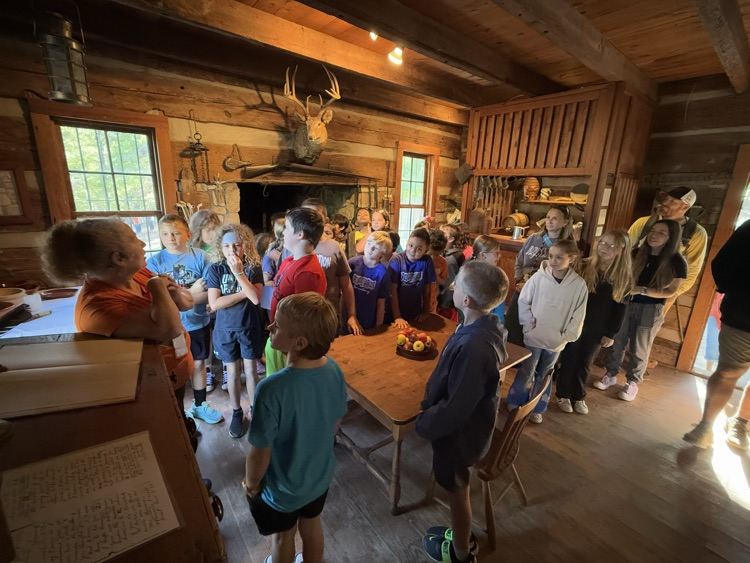 Students tour a cabin at Hart Square.