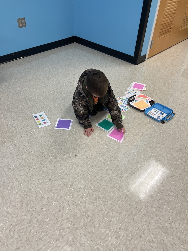 First grade students working on a STEM activity.