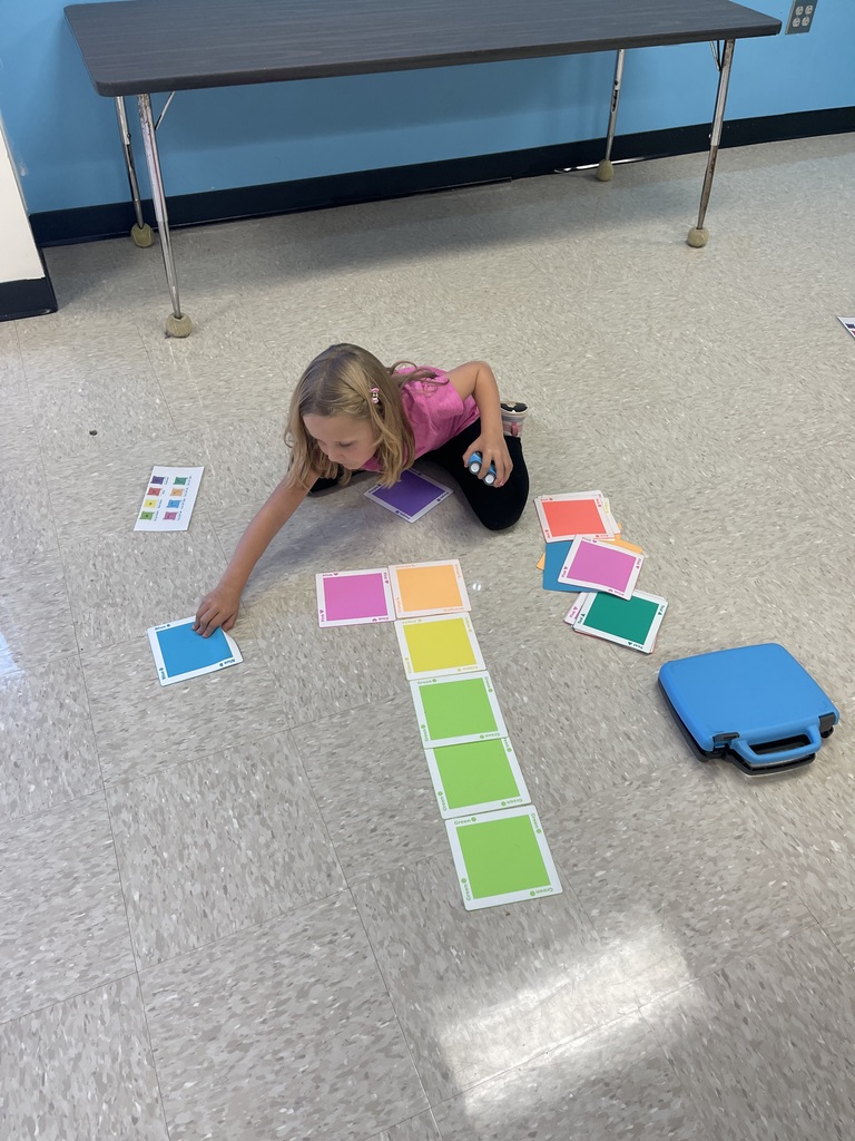 First grade students working on a STEM activity.