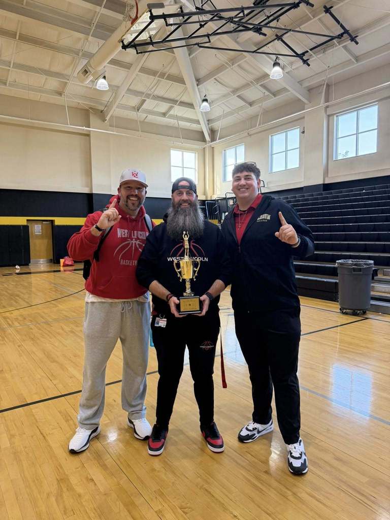 Coaches holding trophy