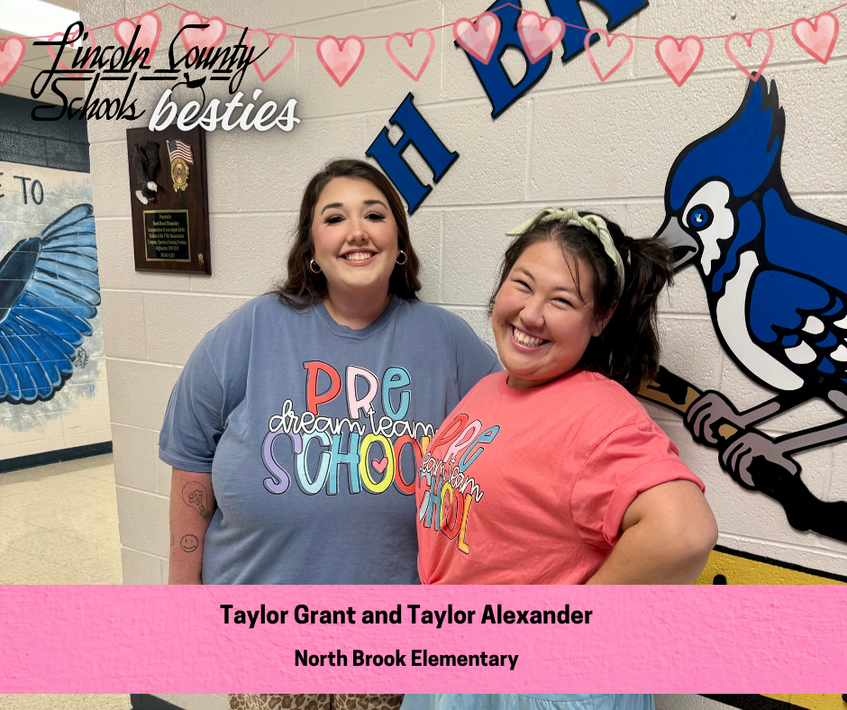 Two adults stand side by side in a school hallway, smiling at the camera. Both are wearing colorful “Pre-K Dream Team School” T-shirts, one in blue and one in coral. Behind them is a wall with large blue letters and a painted blue jay mascot, along with a mounted plaque. Heart graphics and the text “Lincoln County Schools besties” appear across the top. A pink banner at the bottom reads “Taylor Grant and Taylor Alexander” and “North Brook Elementary.”