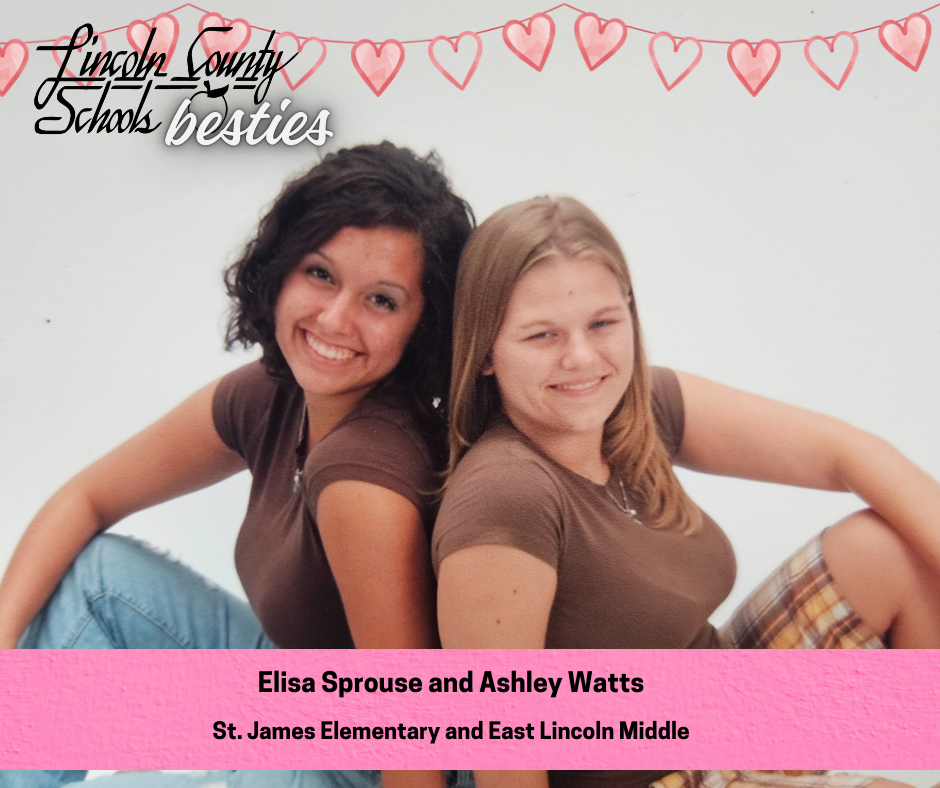 Two young women sit back to back, smiling at the camera, both wearing brown short-sleeve tops and jeans against a light, studio-style background. One has dark, curly shoulder-length hair and the other has straight, light brown hair. Heart graphics and the text “Lincoln County Schools besties” appear across the top. A pink banner at the bottom reads “Elisa Sprouse and Ashley Watts” and “St. James Elementary and East Lincoln Middle.”