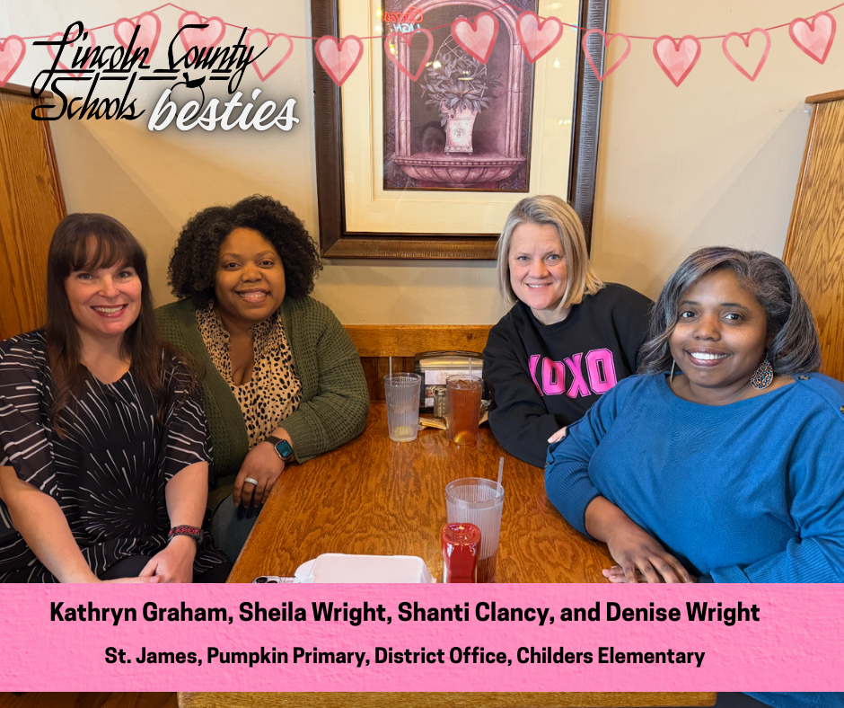 Four adults sit together at a wooden table inside a restaurant, smiling at the camera. Drinks and a small tray are on the table. Behind them is a framed wall picture and wood paneling. From left to right, they wear a patterned black top, a green cardigan over a patterned blouse, a black sweatshirt with pink lettering, and a blue sweater. Heart graphics and the text “Lincoln County Schools besties” appear across the top. A pink banner at the bottom reads “Kathryn Graham, Sheila Wright, Shanti Clancy, and Denise Wright” and “St. James, Pumpkin Primary, District Office, Childers Elementary.”