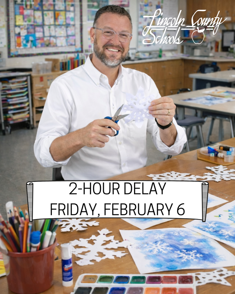 A Lincoln County Schools graphic announcing a 2-hour delay for Friday, February 6. Superintendent Dr. Allen sits in an elementary art classroom smiling while cutting out a paper snowflake with scissors. Student artwork, watercolor paints, glue sticks, and colored pencils are spread across the table, with additional snowflake cutouts visible. The Lincoln County Schools logo appears in the top right corner, and a white banner across the bottom reads “2-Hour Delay – Friday, February 6.”