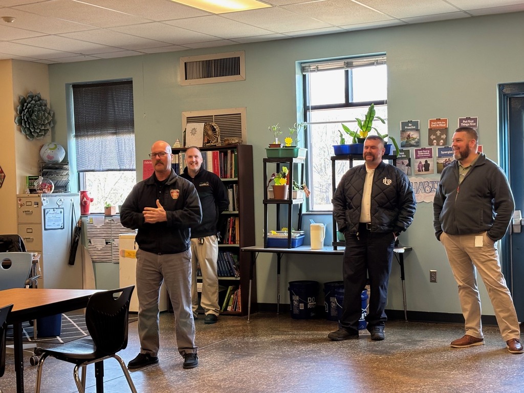 Four city employees talking to students.