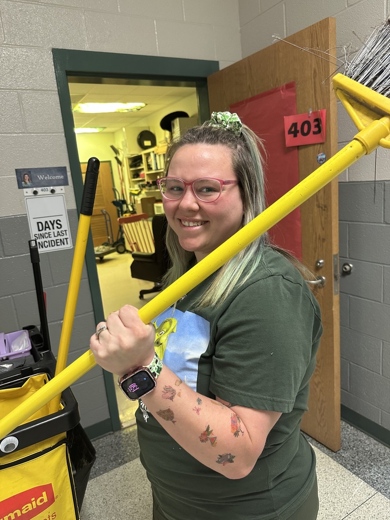 Staff member proudly display colorful temporary tattoos on their arms during the 'Tattoo the Teacher' fundraiser.