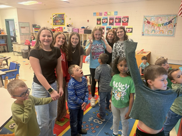 Middle School Student reading with NCES students