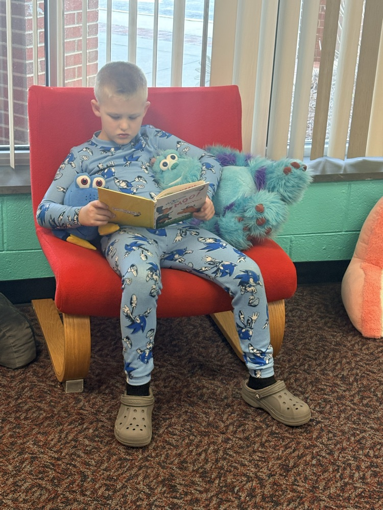 student reading books in pajamas 