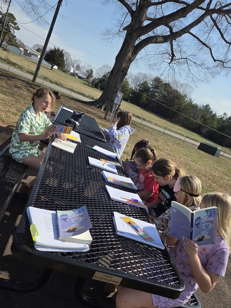 student reading books in pajamas