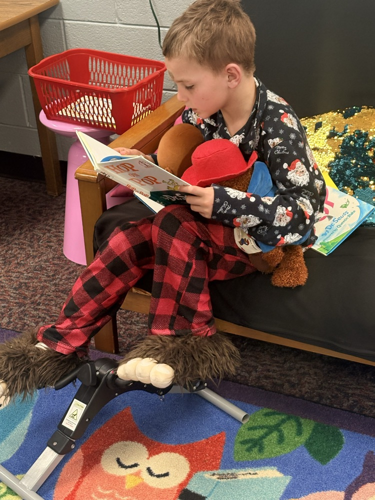 student reading books in pajamas