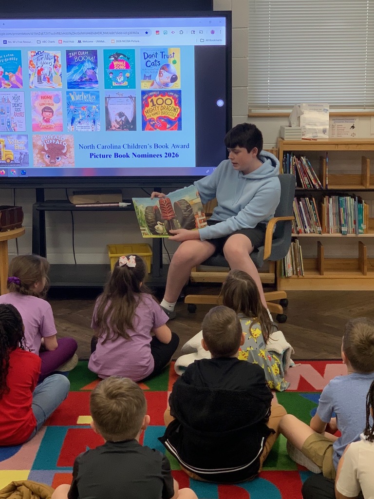 High School students and teachers reading to elementary students to celebrate Dr. Seuss Week.