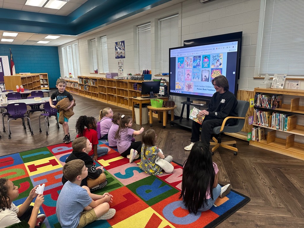 High School students and teachers reading to elementary students to celebrate Dr. Seuss Week.