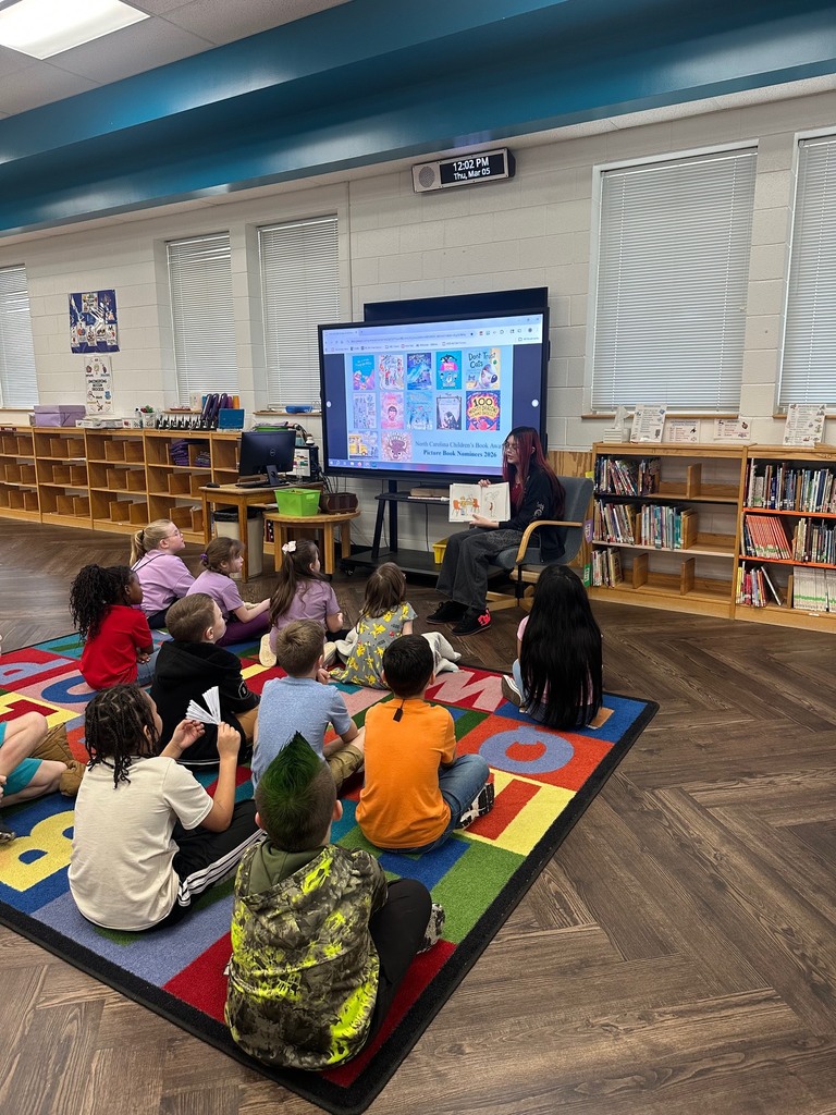 High School students and teachers reading to elementary students to celebrate Dr. Seuss Week.