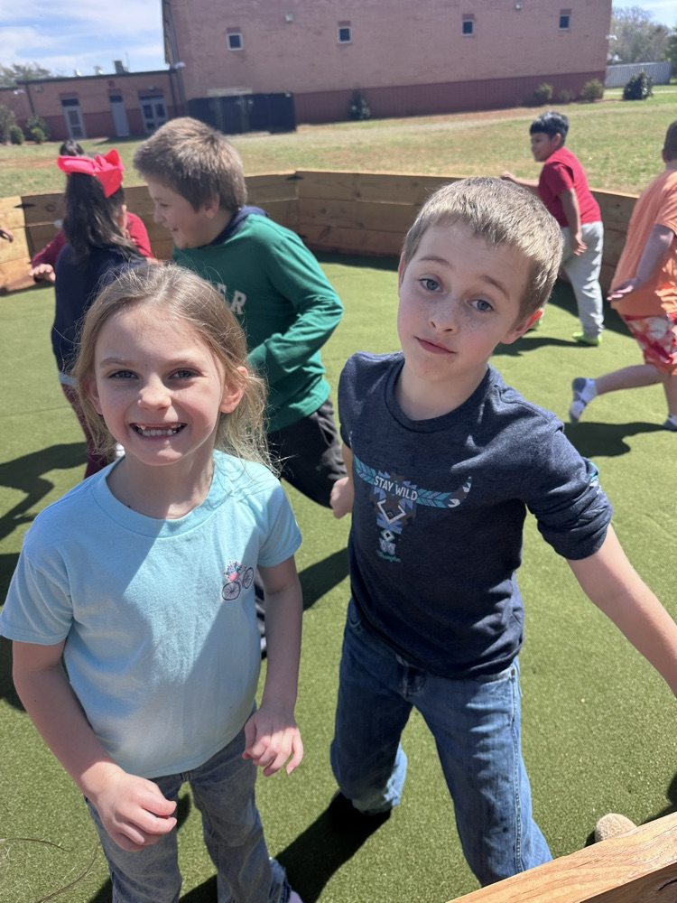 two second graders enjoying the new turf
