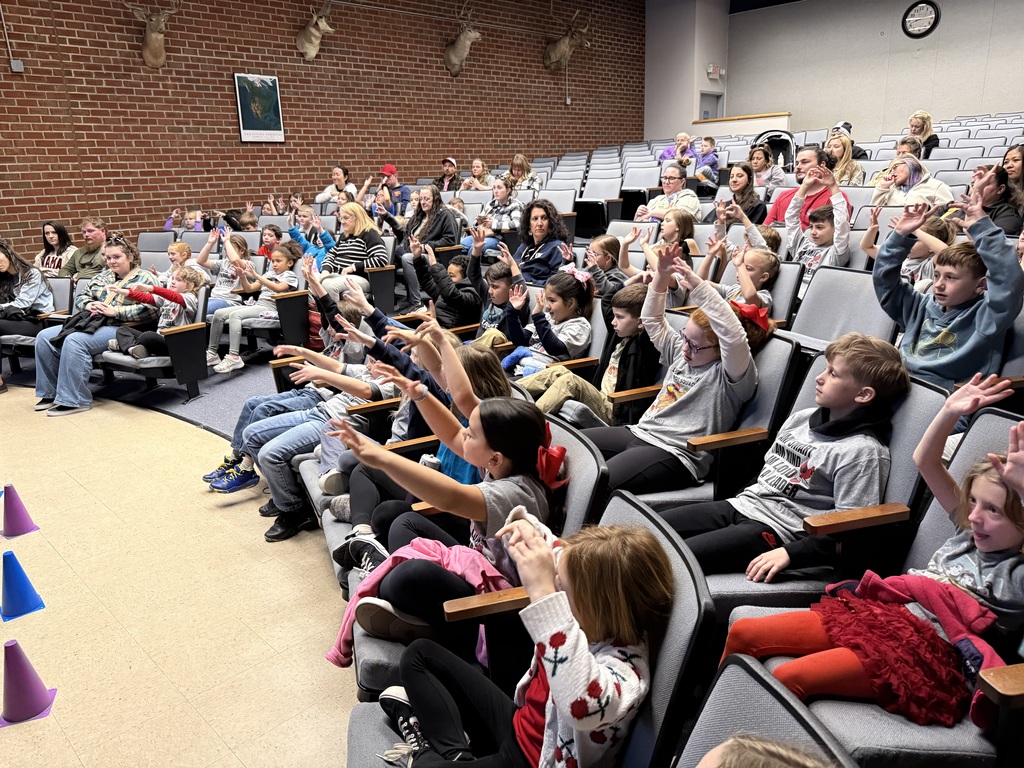 a group of students engaged in a information session while on a field trip