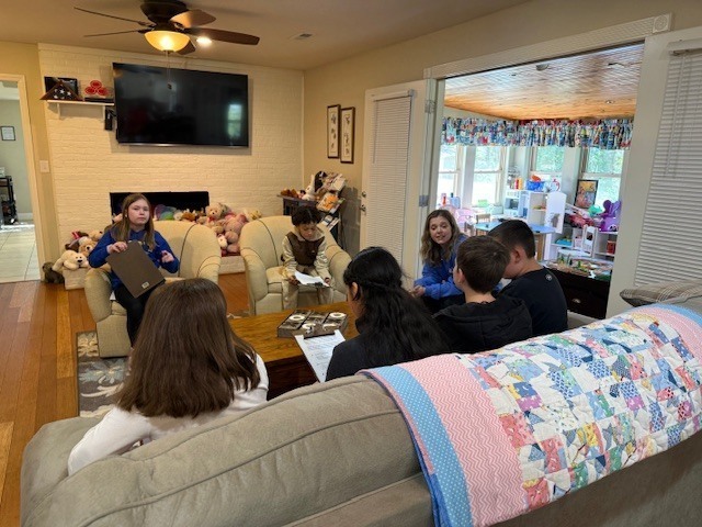 Students interviewing adults at the CAC