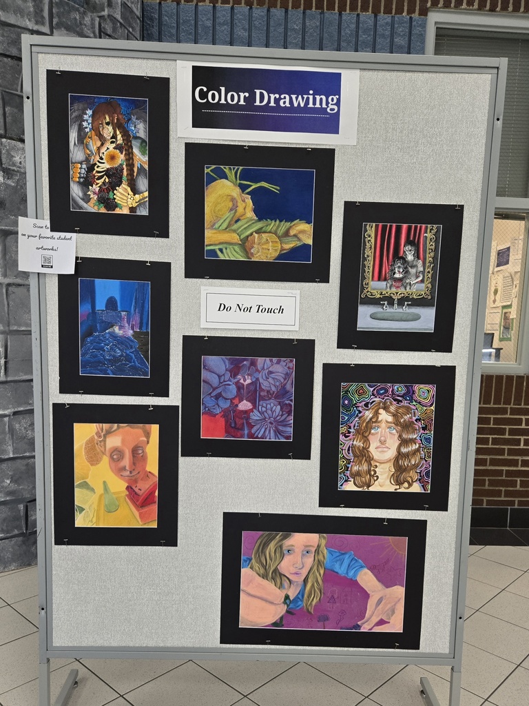 8 colored drawings hang on a board.