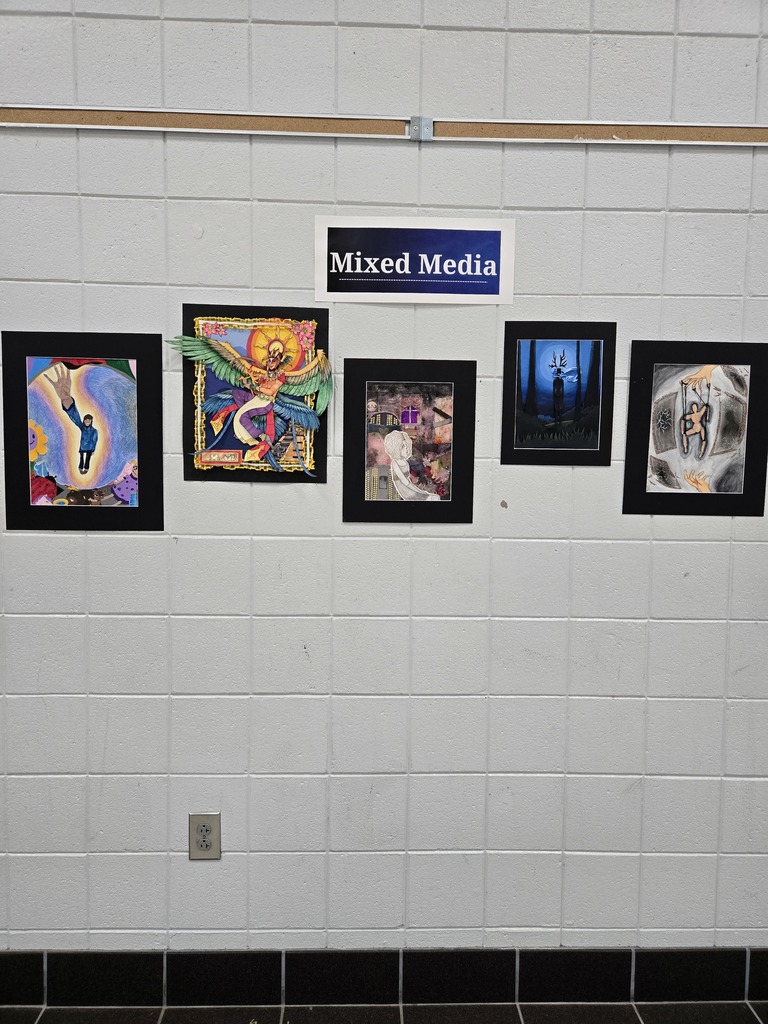 5 mixed media framed artworks hang on a wall