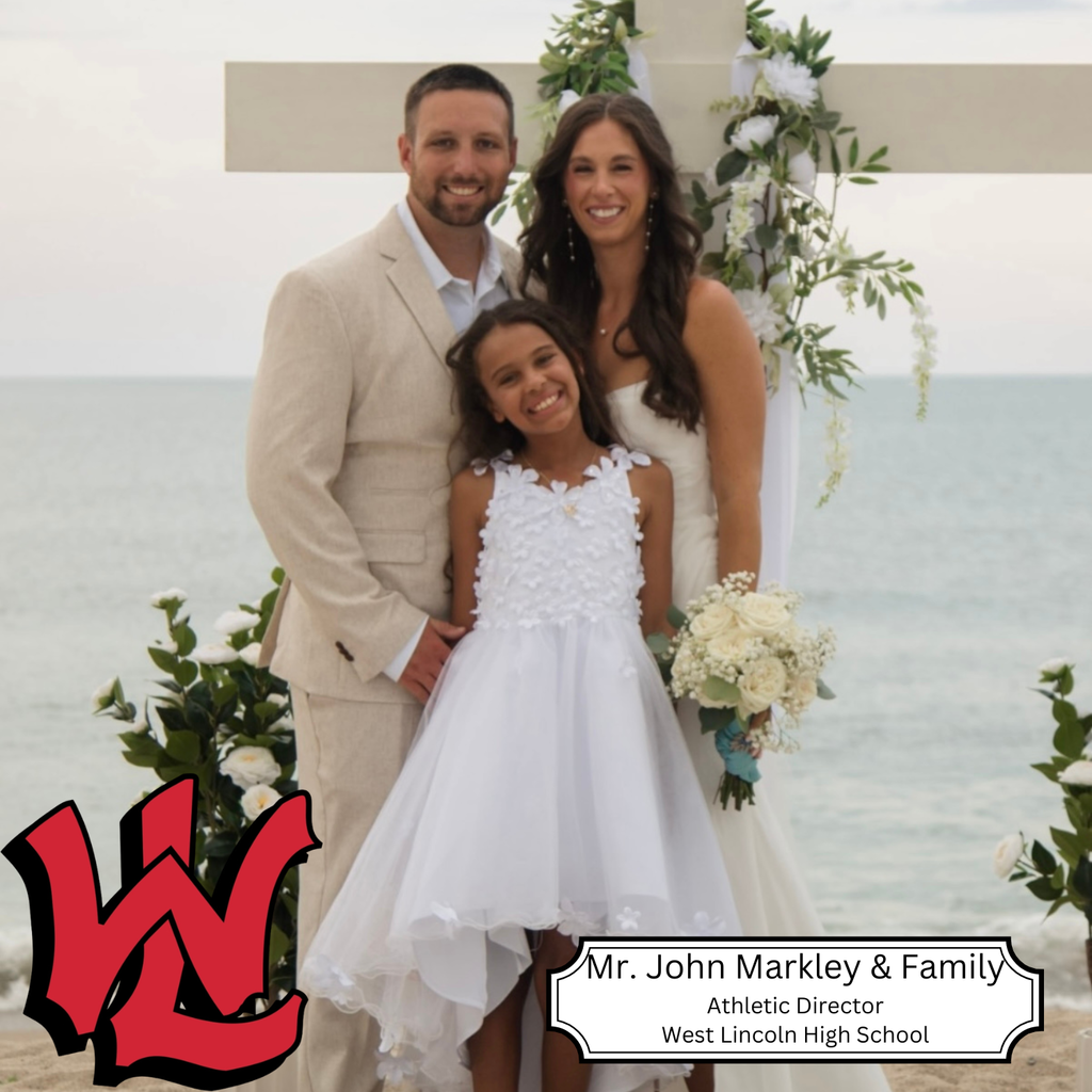 A family of three stands on a beach. The man and woman hold hands, and the girl holds a bouquet.