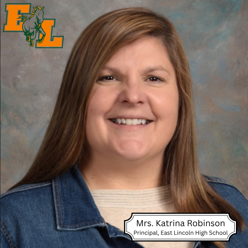 Woman with long hair smiling, wearing a denim jacket. Background has a light blue color and a logo.