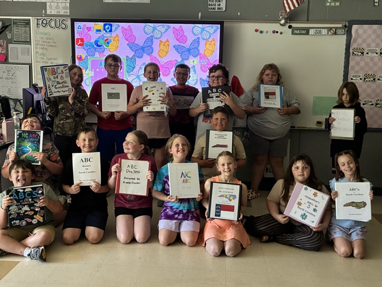 Mrs. Reeder’s students holding their NC Scrapbooks