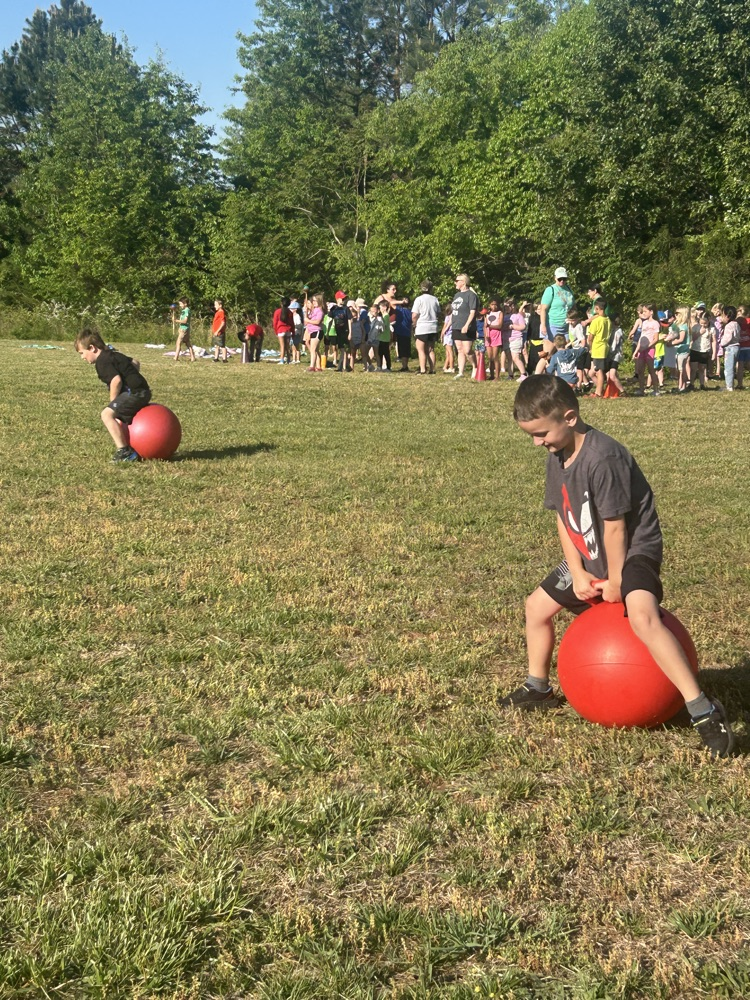 students participating in bouncy ball relay race.