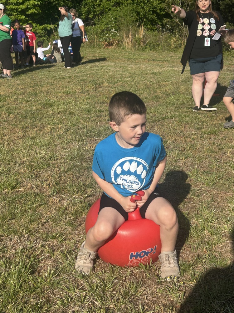 students participating in bouncy ball relay race. 