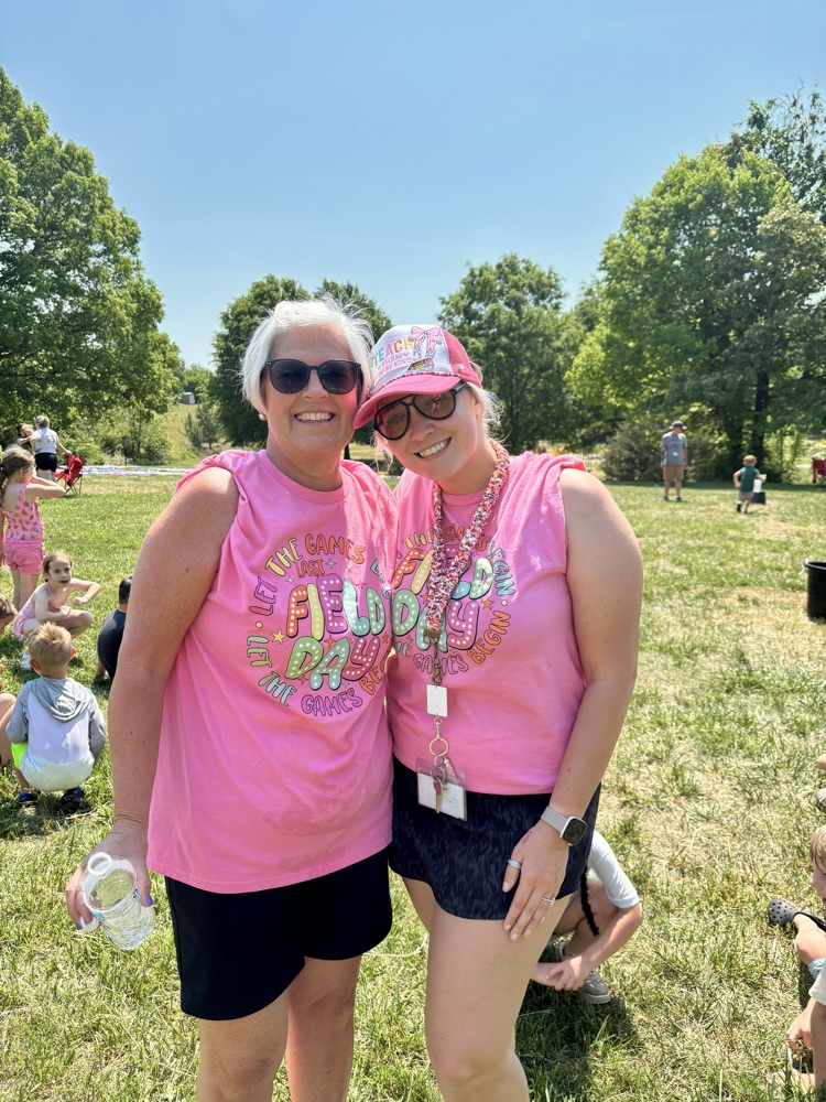 two women in pink shirts smiling