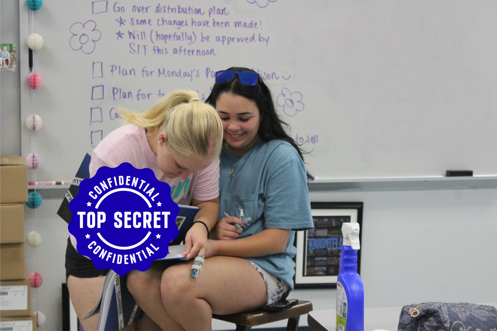 Yearbook students signing their yearbooks. 