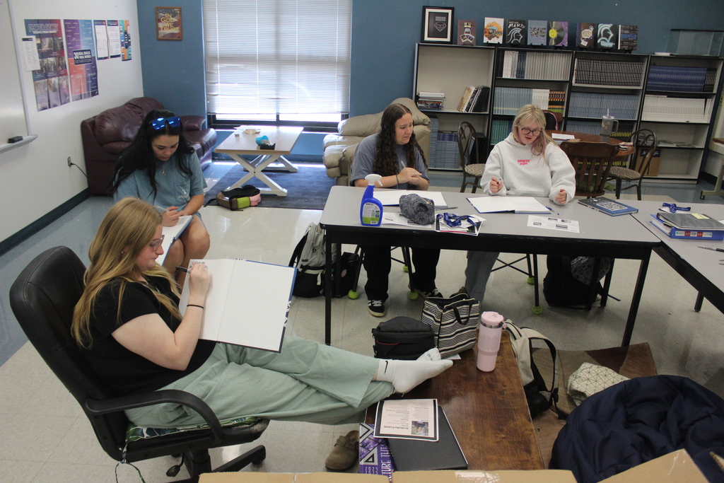 Yearbook students signing their yearbooks. 