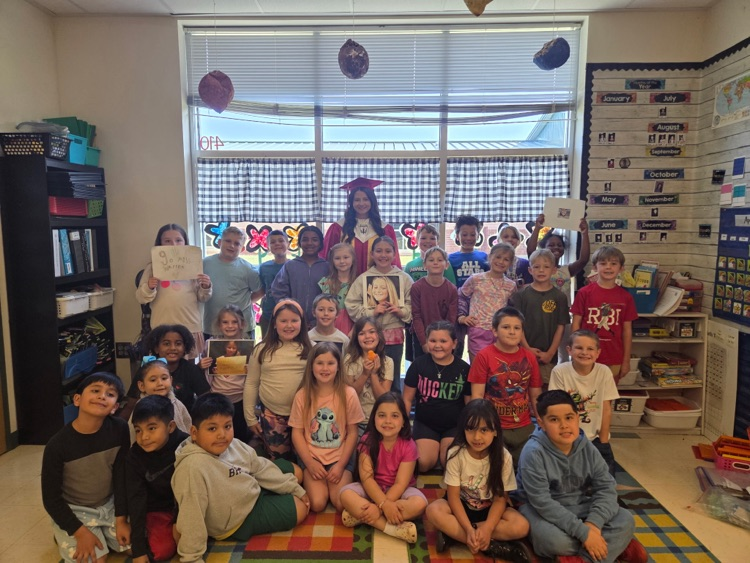 second grade students with teacher cadet 
