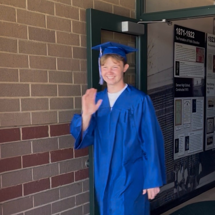 North Lincoln High School seniors coming out of front door of Rock Springs in graduation attire