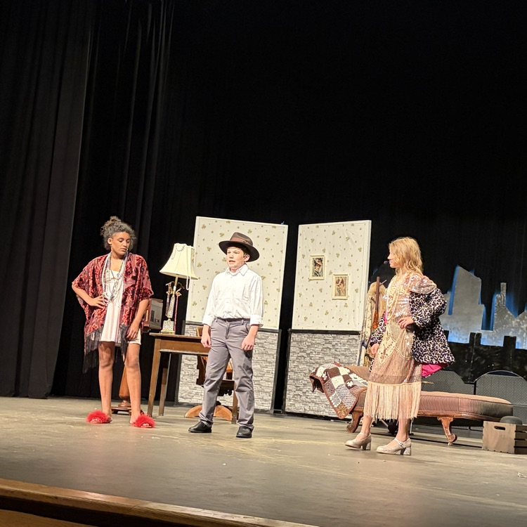 Three students on stage 