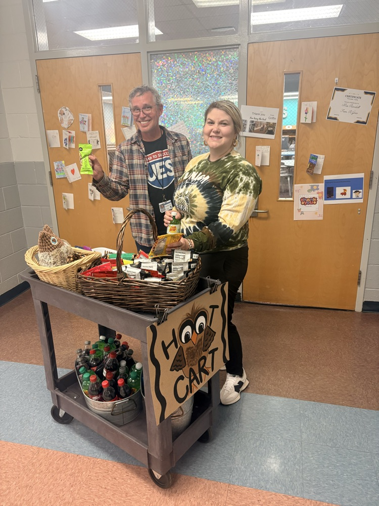 two people getting treats off a cart