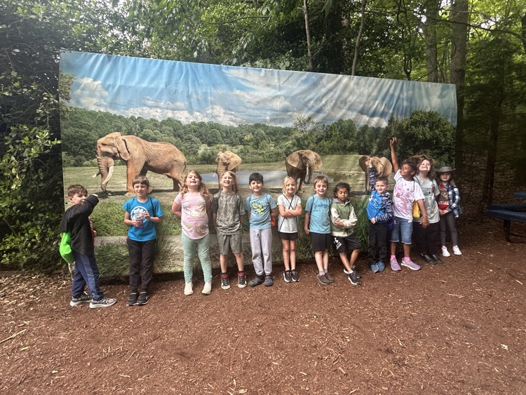 Our kids in front of an elephant picture. 