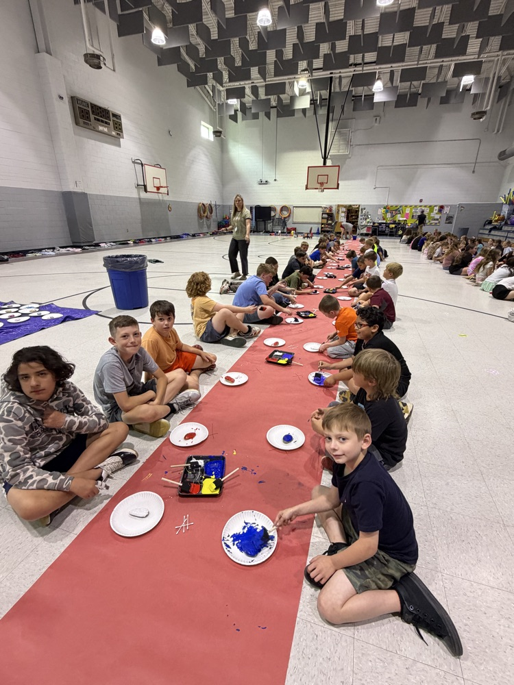 students painting rocks