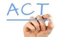 A hand writes "ACT" in blue on a white background. The hand is positioned centrally, with fingers extended.