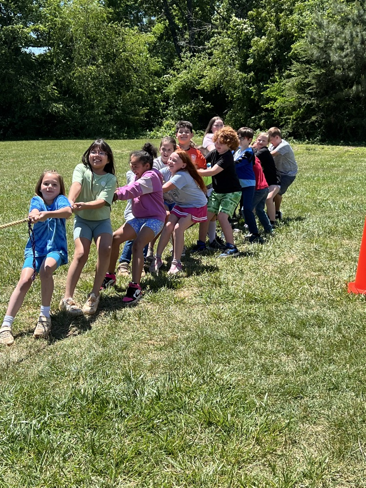 students outside playing tug a war