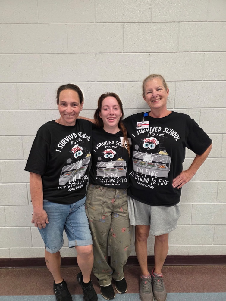 3 ladies smiling in black shirts