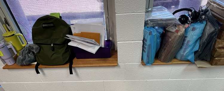 items displayed are a light purple tumbler, a bright yellow tumbler, a green Trailmaker backpack, and a purple plastic bin