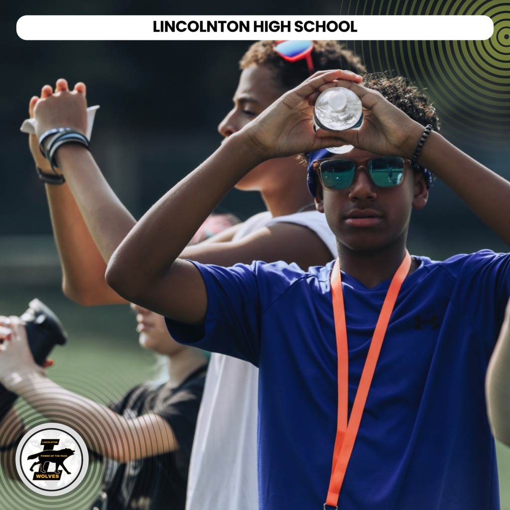 Students at an outdoor event, one holding a coin with others behind, text overlay reads "LINCOLNTON HIGH SCHOOL".